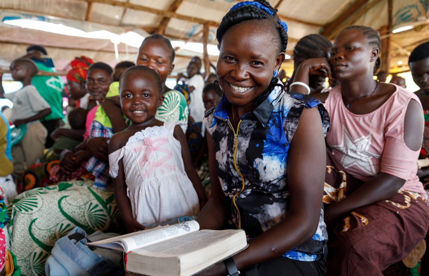 Uganda frau in kirche mit bibel